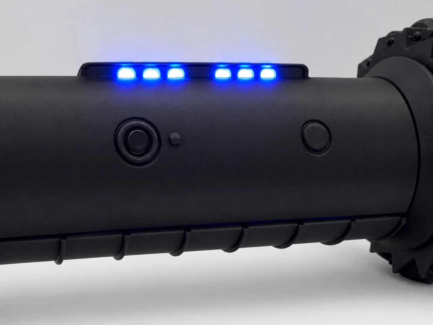 Close-up of the RCD-01's LED bar with its six blue LEDs lit, above the printed camera ring and button