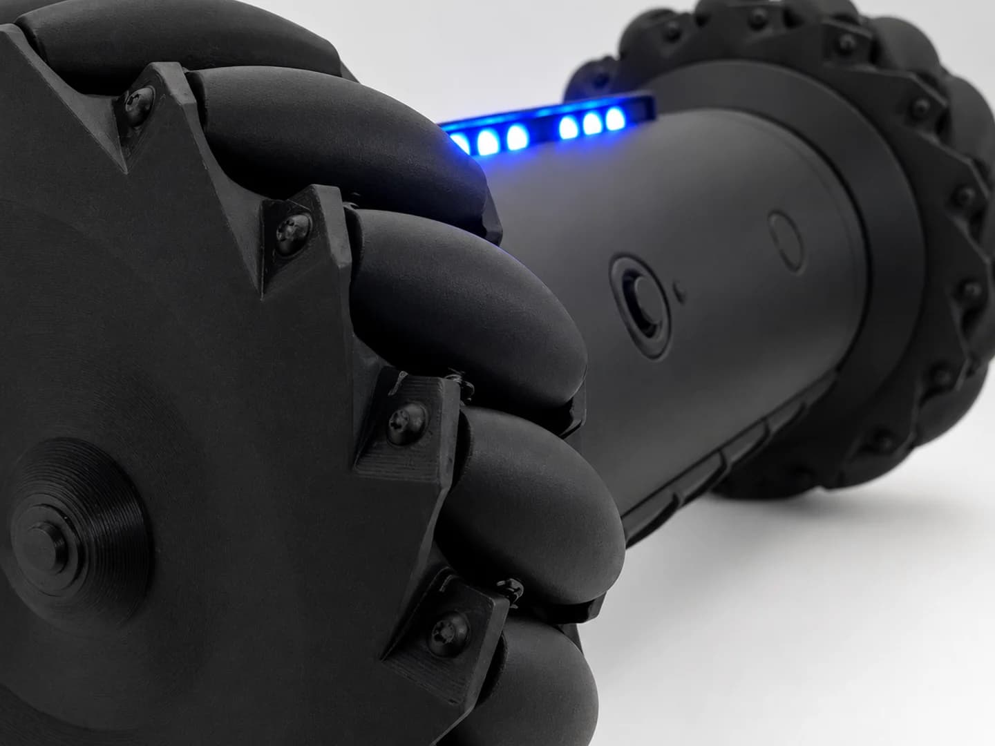 Close-up of an RCD-01 wheel's angled paddle rollers, with the lit LED bar behind